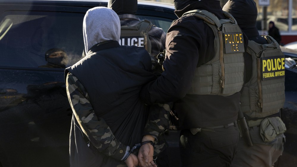 A Federal Agent arrest a man after stopping and questioning him in the street during an Immigration Enforcement Operation on Jan. 14, 2026 in Minneapolis.