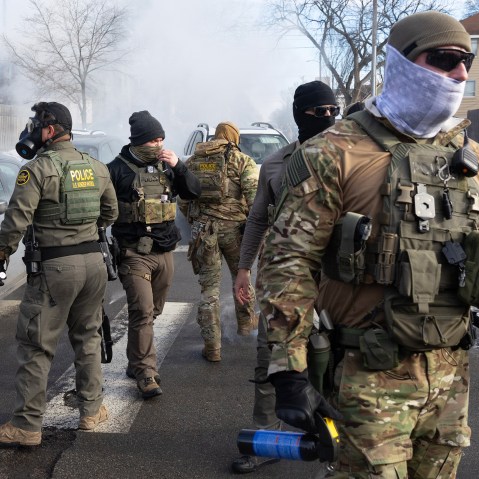 Federal agents walk in the street.