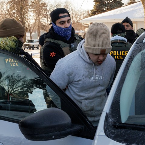 Immigration and Customs Enforcement (ICE) agents detain a young man while conducting federal enforcement operations on Jan. 27, 2026 in St. Paul, Minnesota.