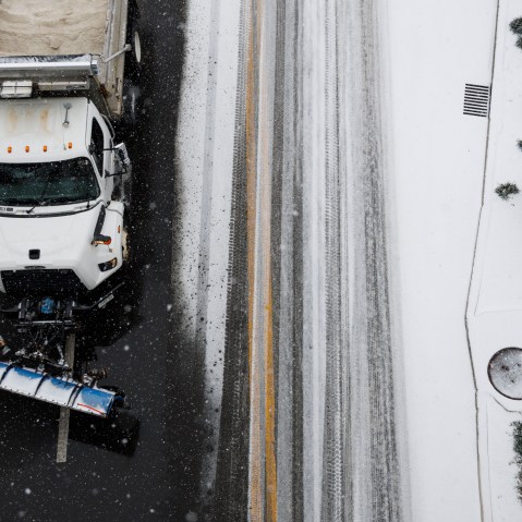 A plow truck drives down First Avenue as snow falls in the lower Broadway area on January 24, 2026 in Nashville, Tennessee. A massive winter storm is bringing frigid temperatures, ice, and snow to millions of Americans across the nation.