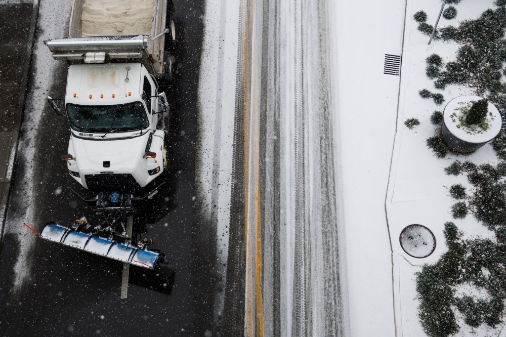 A plow truck drives down First Avenue as snow falls in the lower Broadway area on January 24, 2026 in Nashville, Tennessee. A massive winter storm is bringing frigid temperatures, ice, and snow to millions of Americans across the nation.