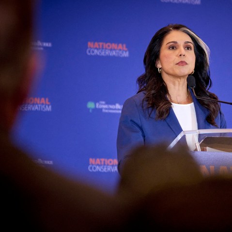 Tulsi Gabbard seen on stage through the audience's heads.