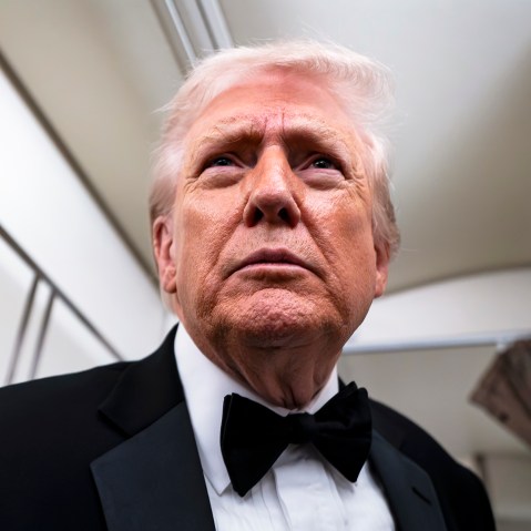 President Donald Trump speaks to reporters and members of the media on board Air Force One while flying in between Washington and West Palm Beach, Fla.