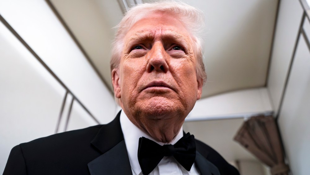 President Donald Trump speaks to reporters and members of the media on board Air Force One while flying in between Washington and West Palm Beach, Fla.