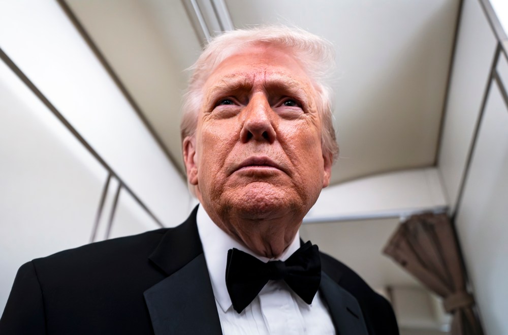 President Donald Trump speaks to reporters and members of the media on board Air Force One while flying in between Washington and West Palm Beach, Fla.