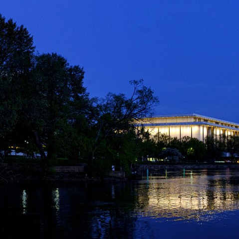 The Kennedy Center reflected in the Potomac River at dusk.