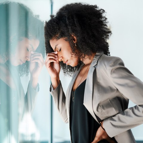 Shot of a young black businesswoman looking stressed out in an office.