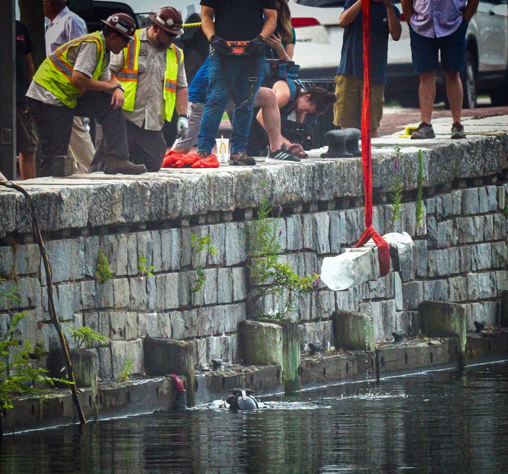 A piece of the Christopher Columbus statue is pulled from the harbor on July 6, 2020 in Baltimore.