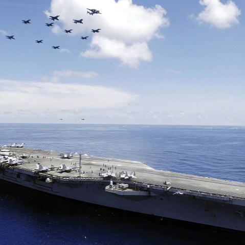 The US Navy (USN) Nimitz-class aircraft carrier USS ABRAHAM LINCOLN (CVN 72) and aircraft assigned to Carrier Air Wing Two (CVW-2) perform an aerial demonstration in the South China Sea.