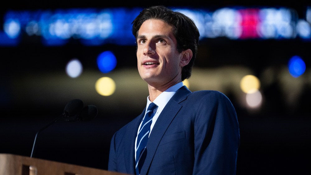 Jack Schlossberg behind a podium with a microphone.