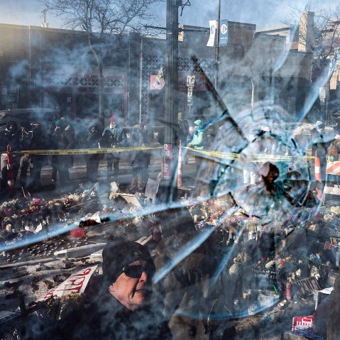 A gun shot perforation in a window pane in front of a makeshift memorial for Alex Pretti in Minneapolis.