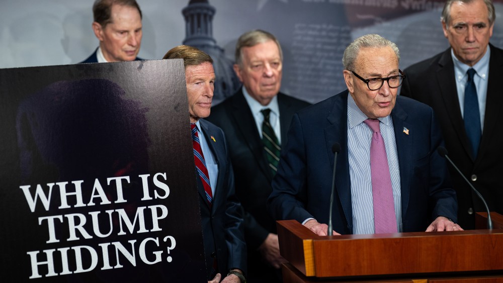 From left: Senator Ron Wyden, Senator Richard Blumenthal, Senator Dick Durbin, Senate Minority Leader Chuck Schumer, and Senator Jeff Merkley. On the left, a poster board that reads "WHAT IS TRUMP HIDING?"