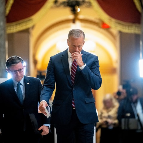 Mike Johnson, left, and John Thune leave. Press can be seen in the background.