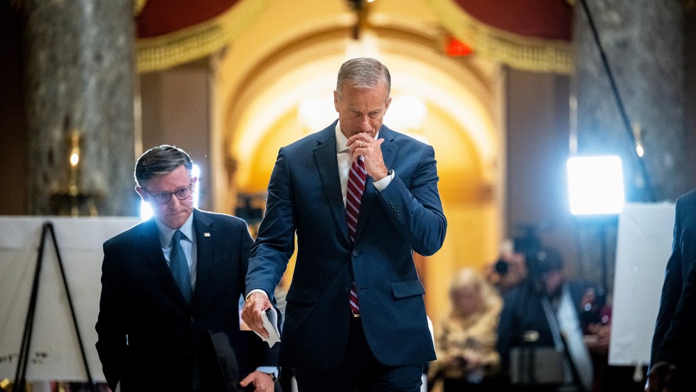 Mike Johnson, left, and John Thune leave. Press can be seen in the background.