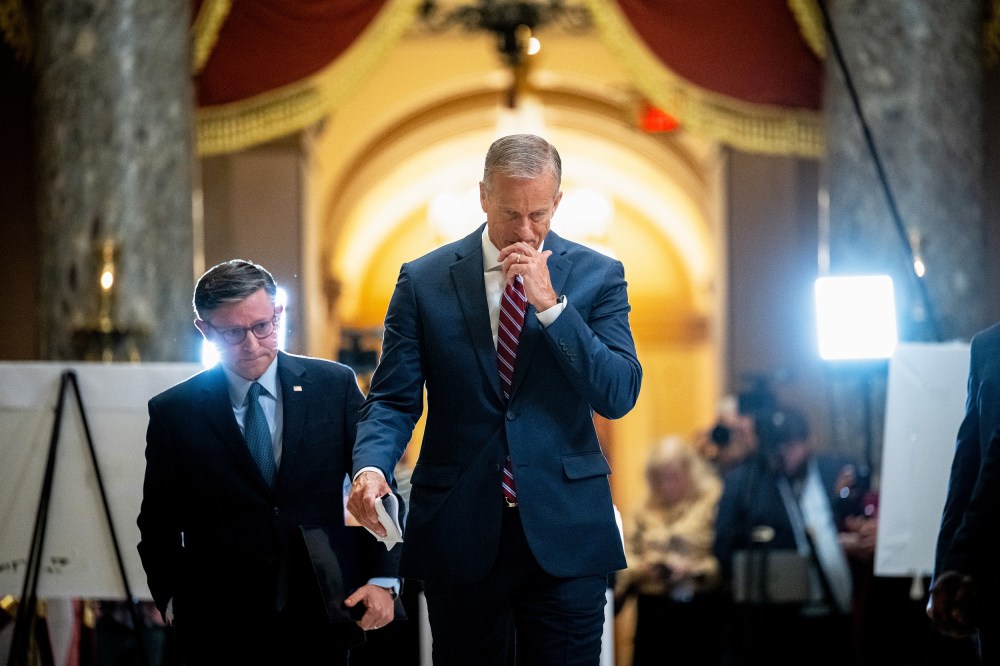 Mike Johnson, left, and John Thune leave. Press can be seen in the background.
