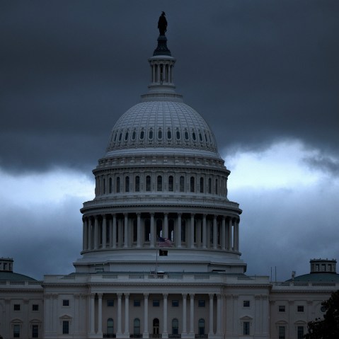 The Capitol building with dark, ominous clouds in the background.