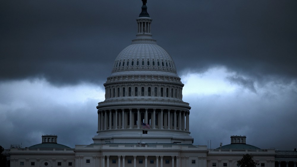 The Capitol building with dark, ominous clouds in the background.