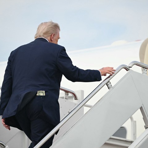 A fifty-dollar bill is seen in President Donald Trump's back pocket as he boards Air Force One.