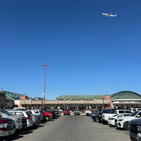 A plane flies over El Paso International Airport.