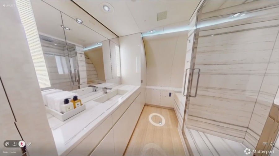 A bathroom, which includes a shower, on the plane.