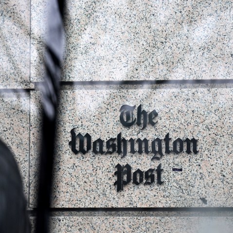 The Post sign is visioble through a glass