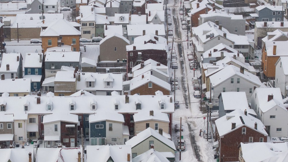 An aerial view of snow-covered homes.