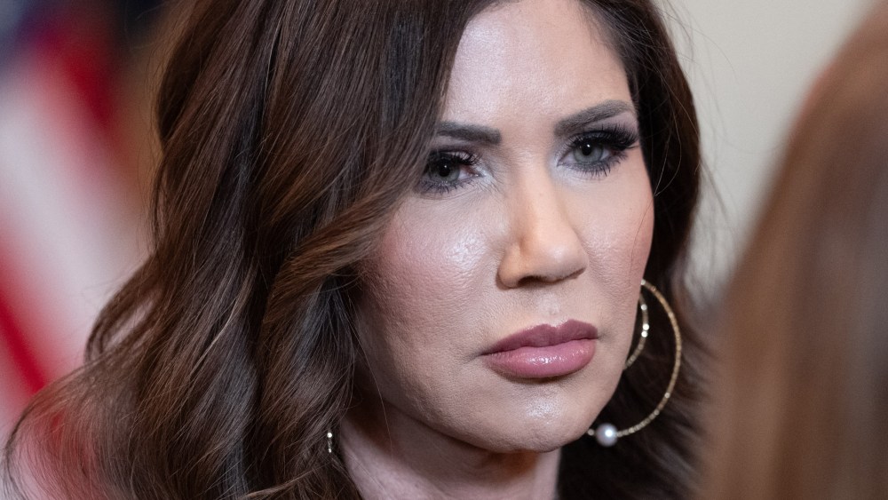 Kristi Noem speaks to another person.