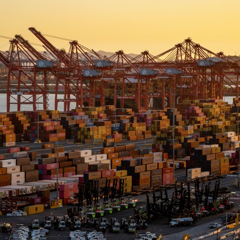 Shipping containers seen in a wide shot at sunset.