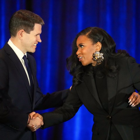 State Representative James Talarico and Representative Jasmine Crockett shake hands during a debate.