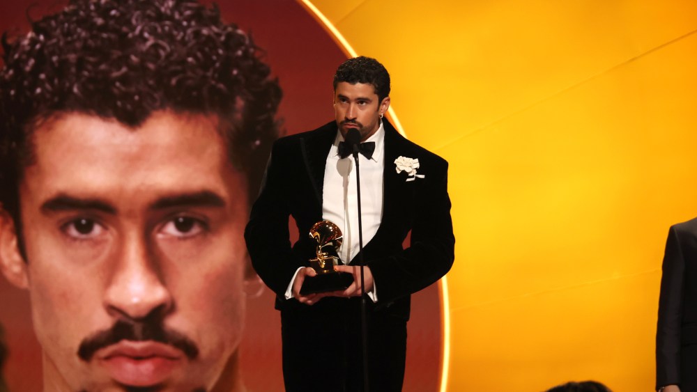 Bad Bunny stands on stage with Grammy Award in hand.