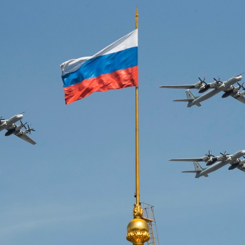 FILE - Russian Tu-95 strategic bombers fly past a Russian flag at the Kremlin complex during a rehearsal for the Victory Day military parade in Moscow, Russia, May 4, 2018. (AP Photo/Pavel Golovkin, File)