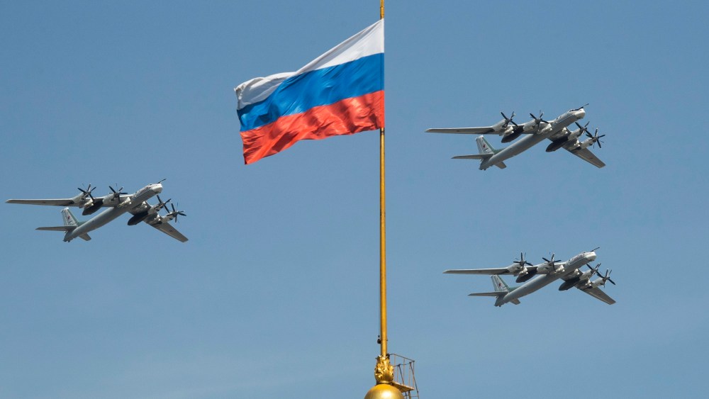 FILE - Russian Tu-95 strategic bombers fly past a Russian flag at the Kremlin complex during a rehearsal for the Victory Day military parade in Moscow, Russia, May 4, 2018. (AP Photo/Pavel Golovkin, File)