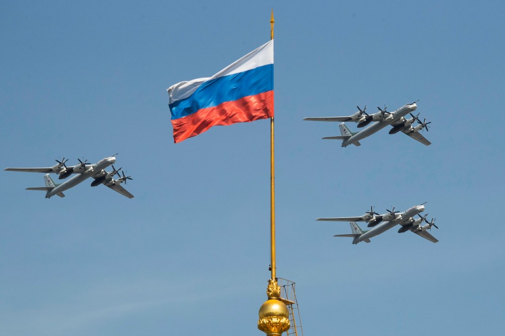 FILE - Russian Tu-95 strategic bombers fly past a Russian flag at the Kremlin complex during a rehearsal for the Victory Day military parade in Moscow, Russia, May 4, 2018. (AP Photo/Pavel Golovkin, File)