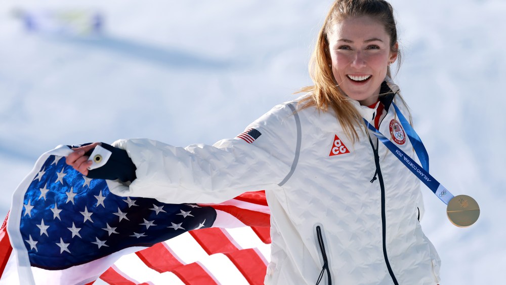 Gold medalist Mikaela Shiffrin of Team United States poses for a photo with a flag after the medal ceremony following the Women's Slalom Run on day twelve of the Milano Cortina 2026 Winter Olympics at Tofane Alpine Skiing Center on February 18, 2026 in Cortina d'Ampezzo, Italy