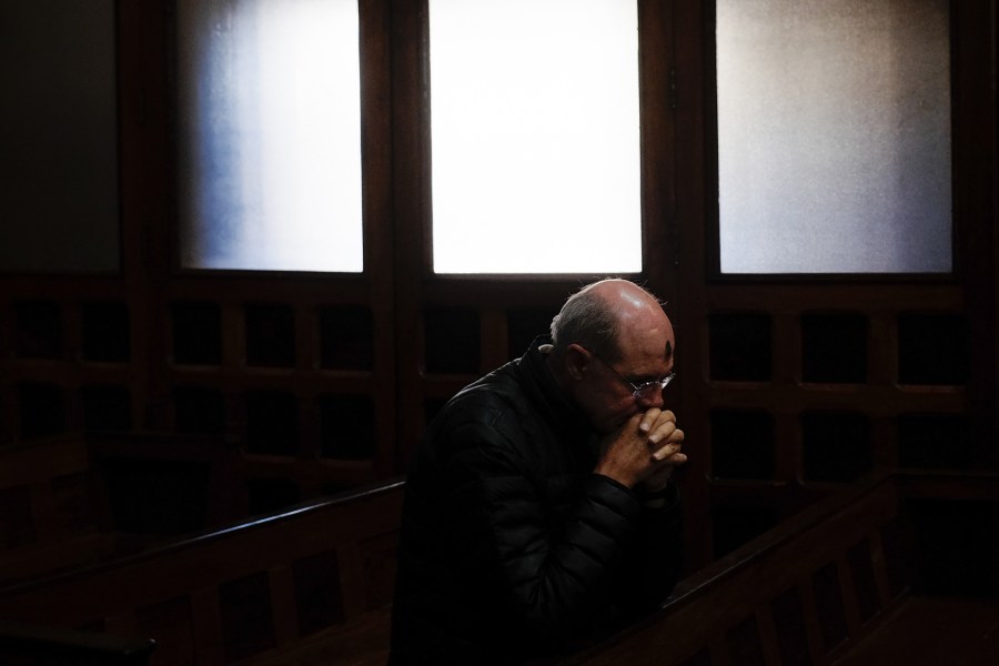 A man prays with ashes on his forehead as part of an Ash Wednesday service in Guadalajara, Mexico.