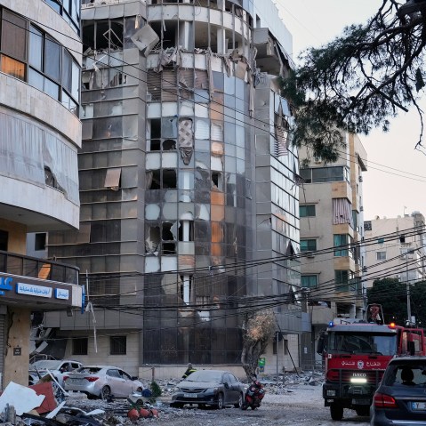Debris covers a street beside an apartment building hit by an Israeli airstrike in Dahiyeh, Beirut's southern suburb.