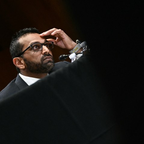 Kash Patel with his hand on his forehead.