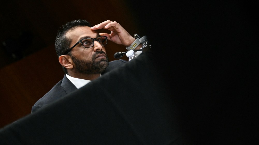 Kash Patel with his hand on his forehead.