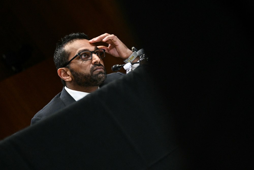 Kash Patel with his hand on his forehead.