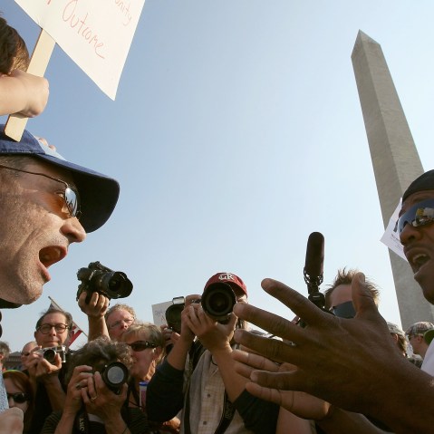 Two men shout at each other in this photo shot from below.