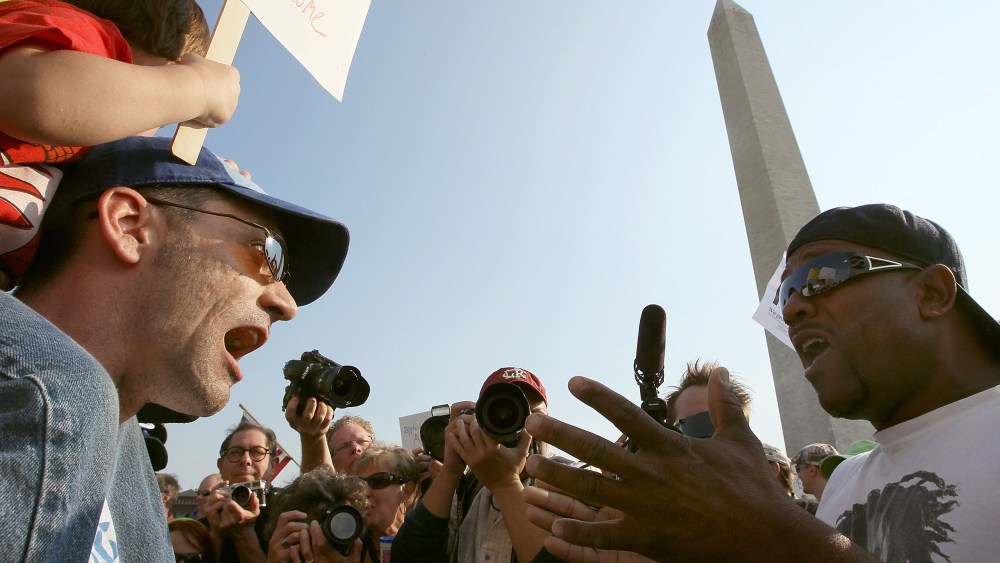 Two men shout at each other in this photo shot from below.