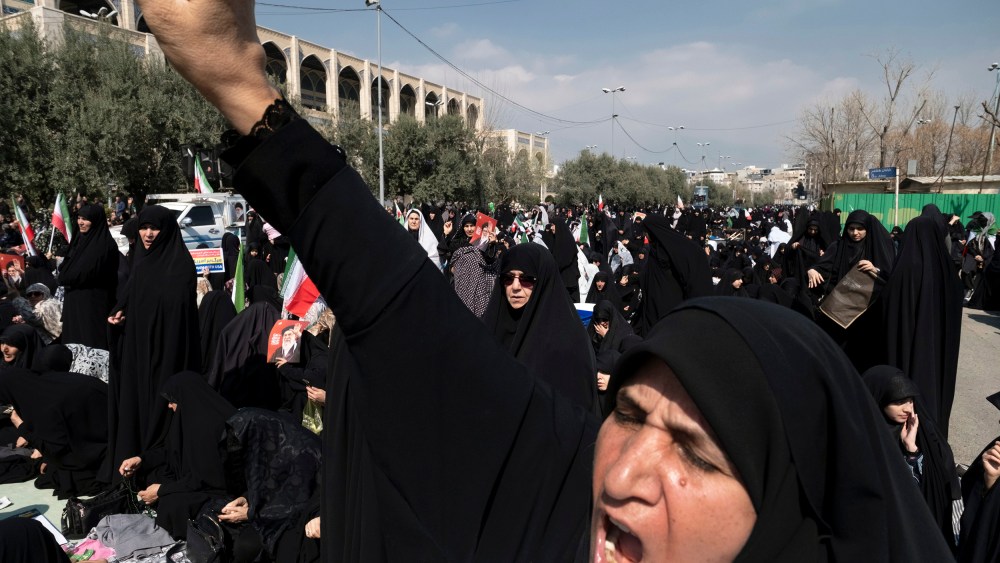 A veiled Iranian worshipper shouts slogans in Tehran.