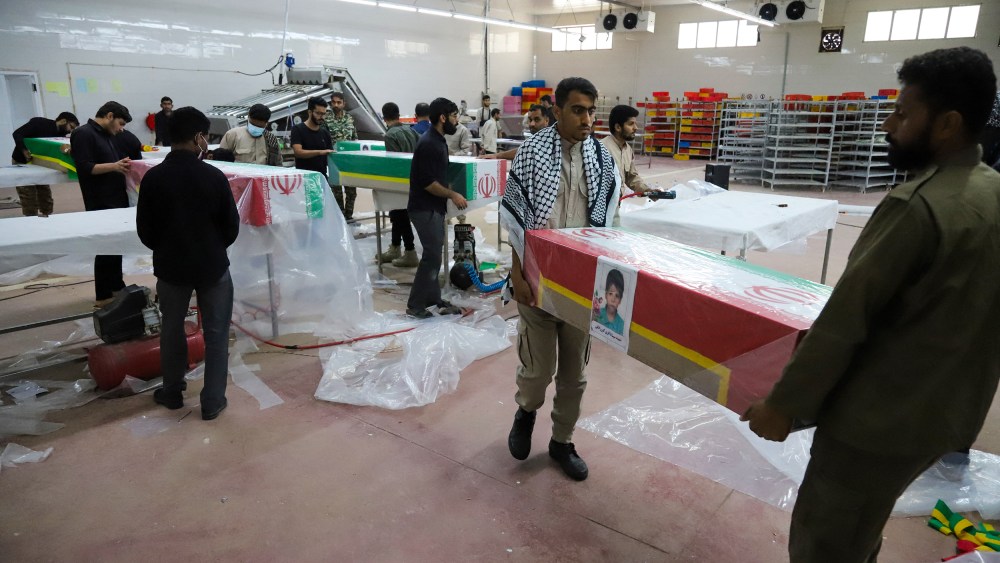 Men carry a casket with a little girl's photo on it.