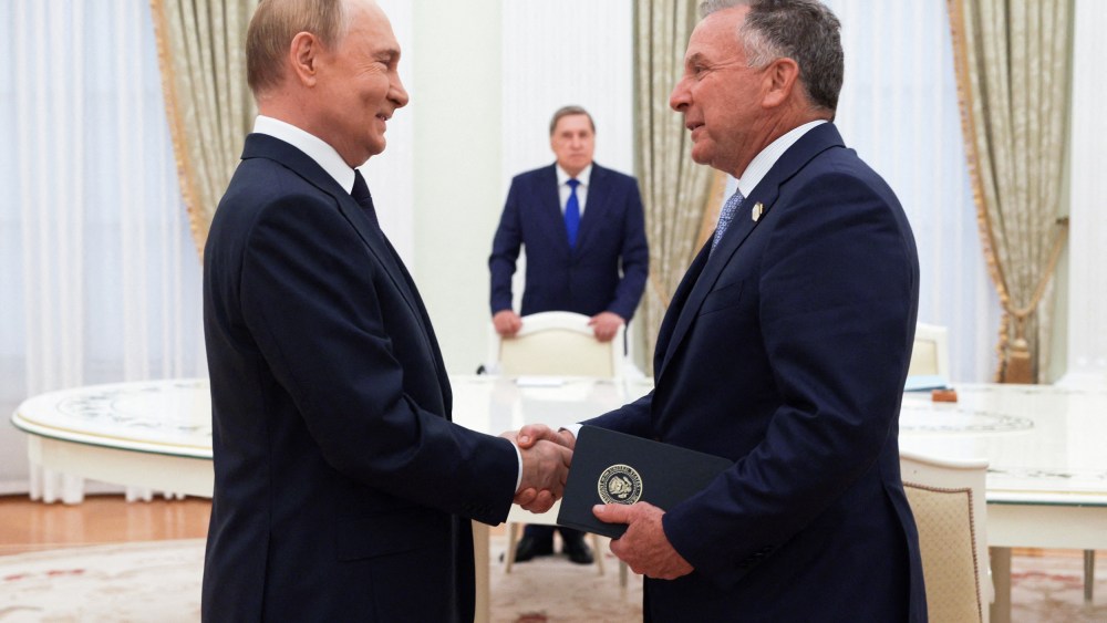 Vladimir Putin, left, shakes hands with Steve Witkoff.