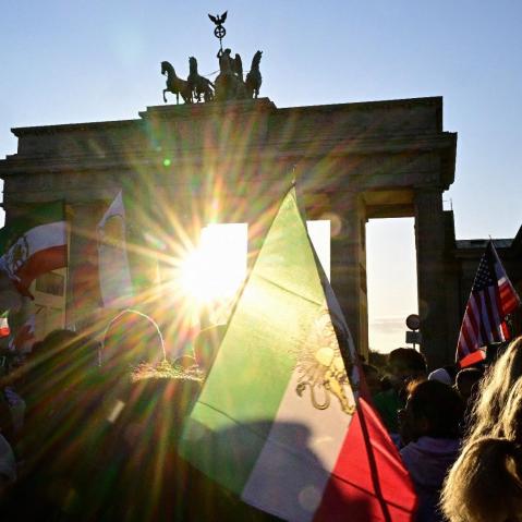 Protesters wave Iranian flags and shout slogans during a demonstration in Berlin, on Mar. 1, 2026.