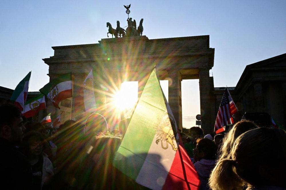 Protesters wave Iranian flags and shout slogans during a demonstration in Berlin, on Mar. 1, 2026.